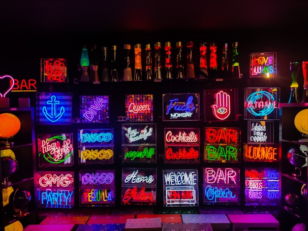 A collection of custom neon signs displayed at an event.