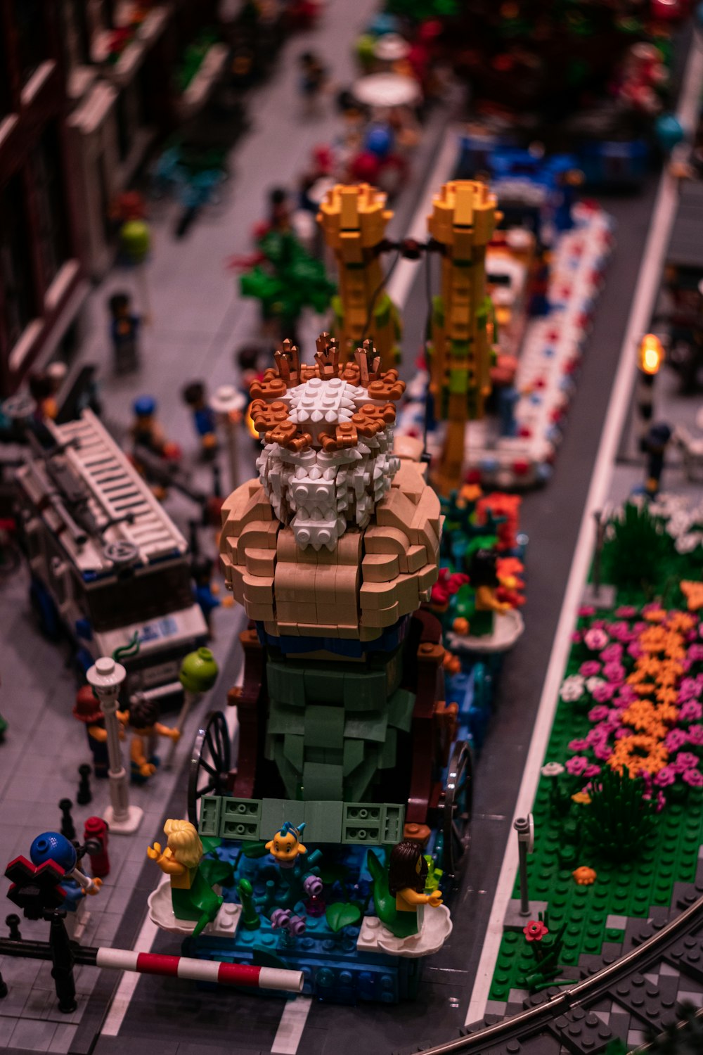 a lego model of a city street with cars and people