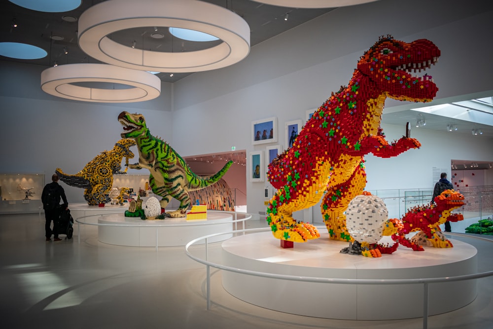 a group of lego dinosaurs on display in a museum