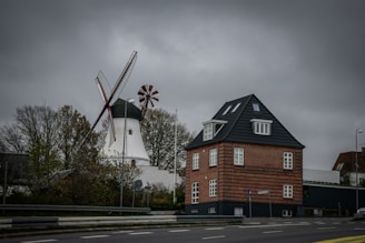 a red brick building with a windmill in the background