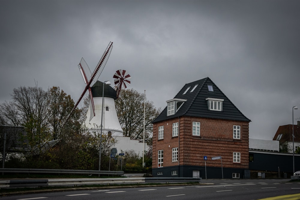 a red brick building with a windmill in the background