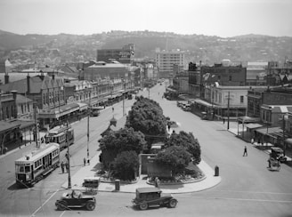 A restored frame from a silent film showing a bustling city square from the 1910s.