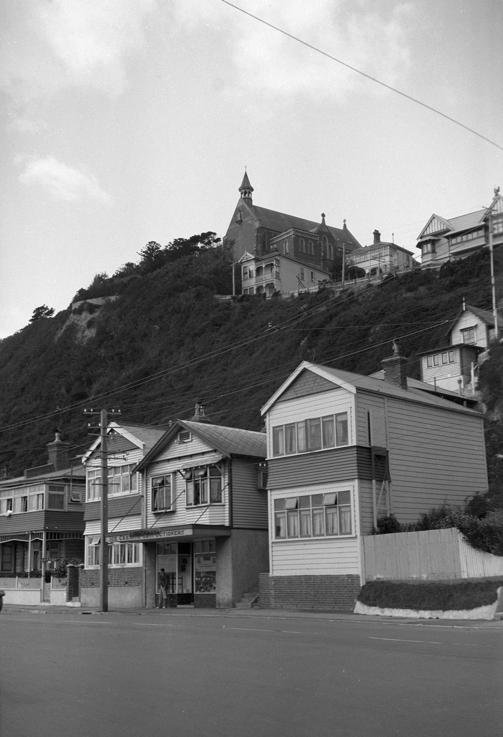 a black and white photo of houses on a hill