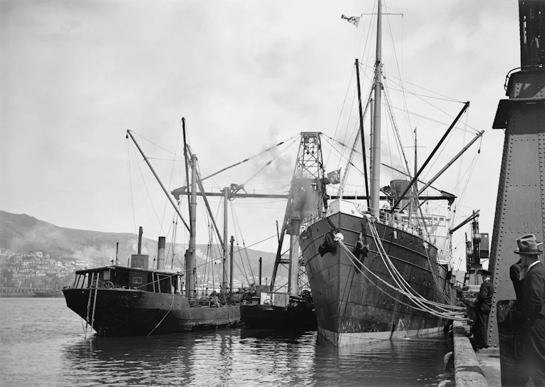 Black and white photo of a bustling 19th-century Passage West dock with fishermen preparing their boats.
