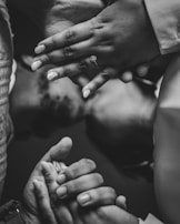A close-up of intertwined hands with wedding rings, symbolizing commitment and happiness.