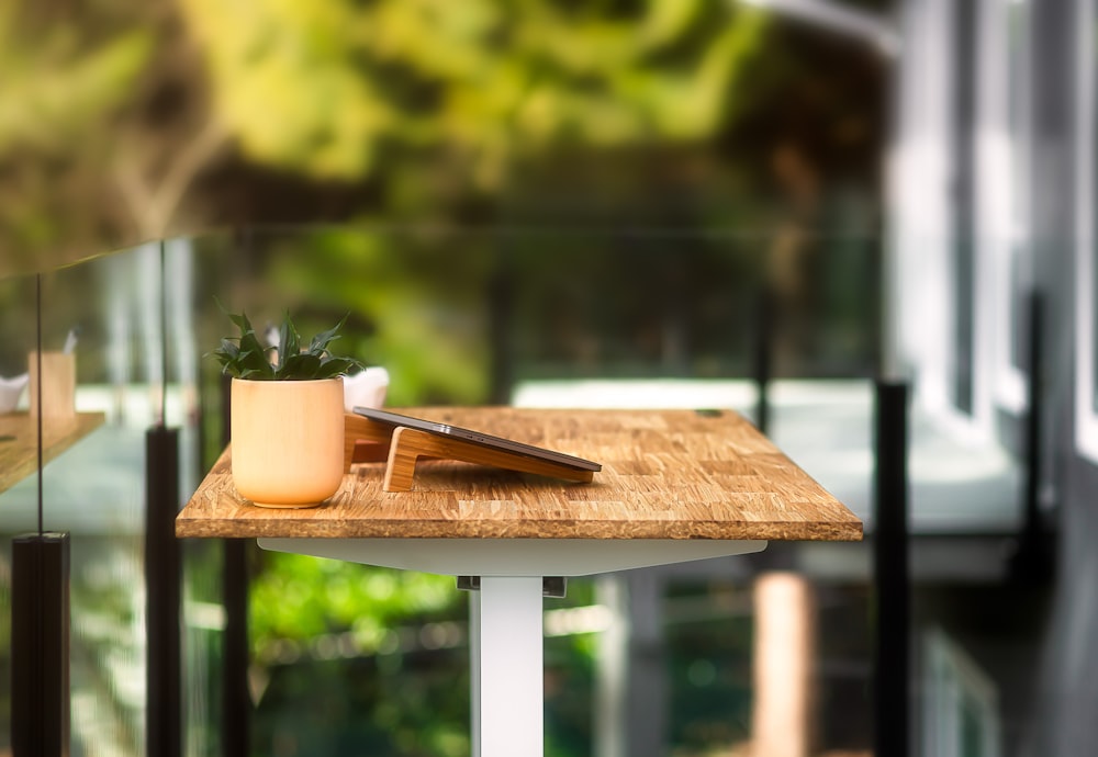 a wooden table with a knife and a potted plant on it
