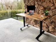 a wooden table with a laptop on top of it