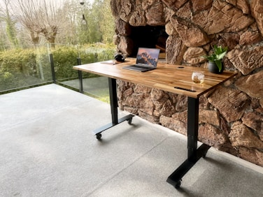 a wooden table with a laptop on top of it