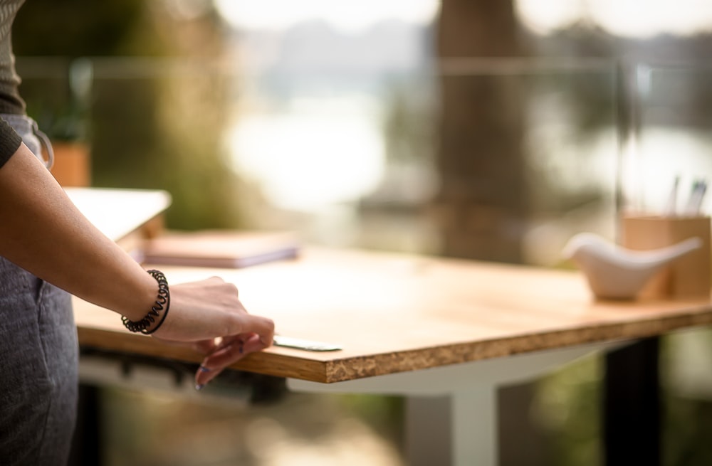 a person standing at a table with a pen in their hand