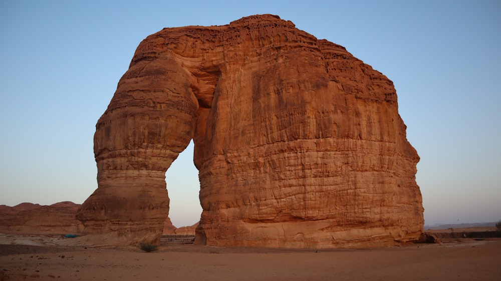 a large rock formation in the middle of a desert