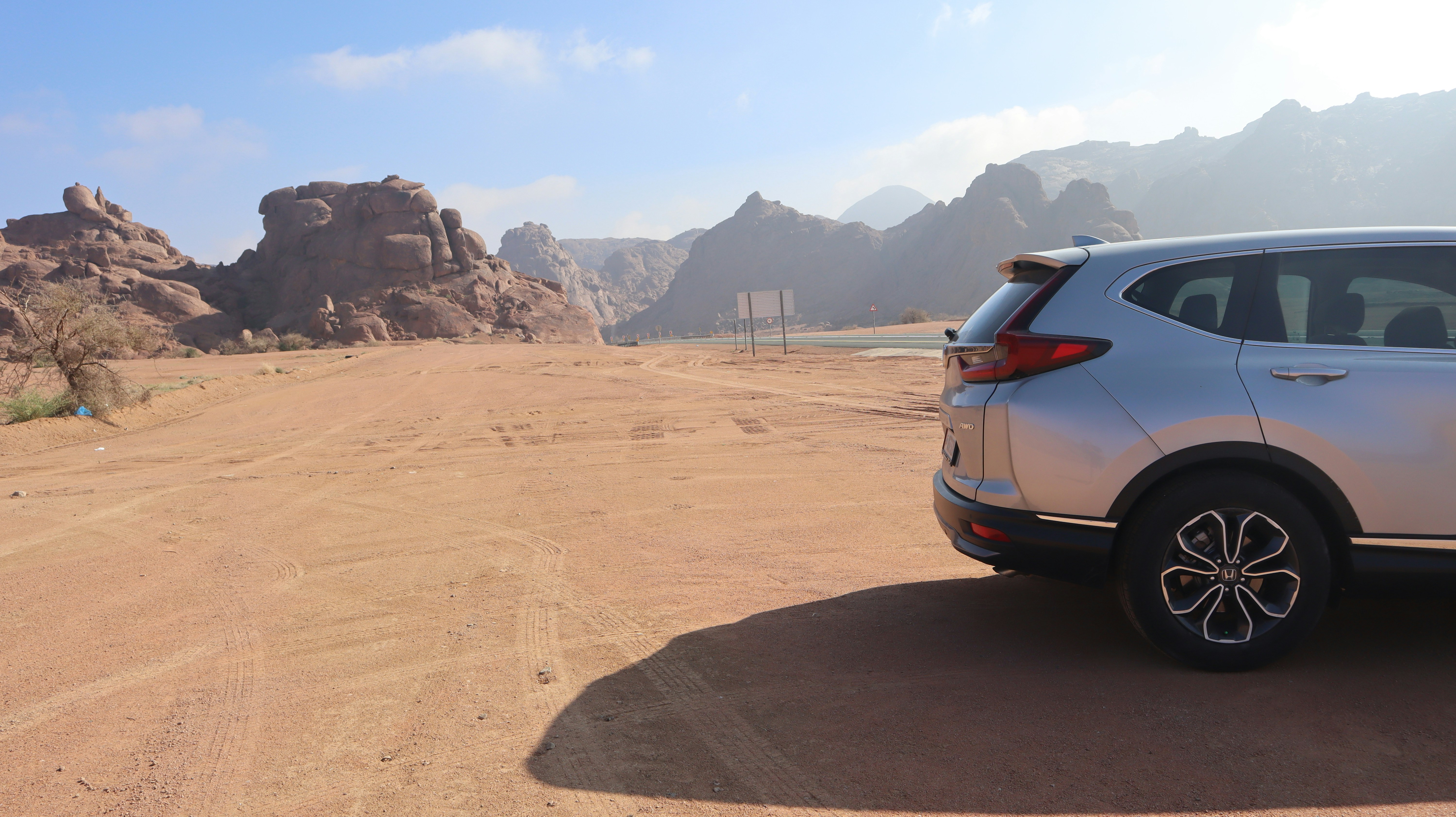 a car parked on a dirt road in the desert