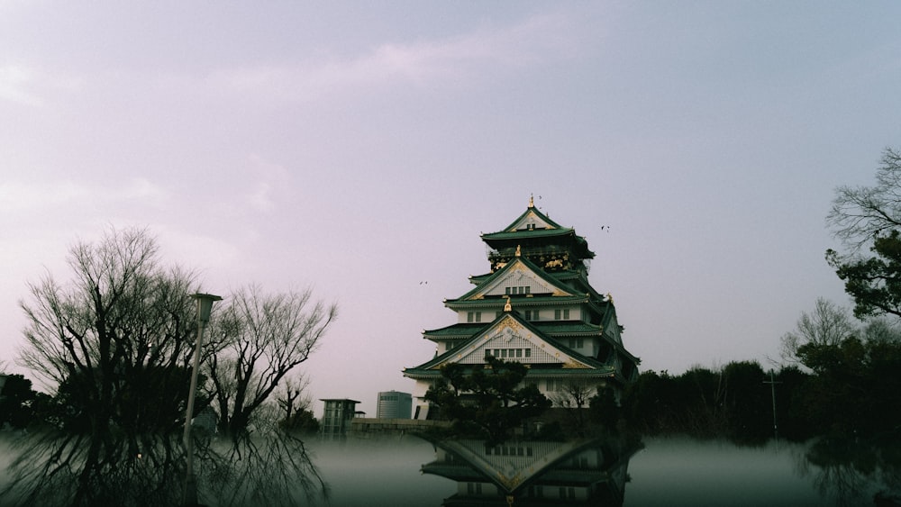 a tall building sitting next to a body of water