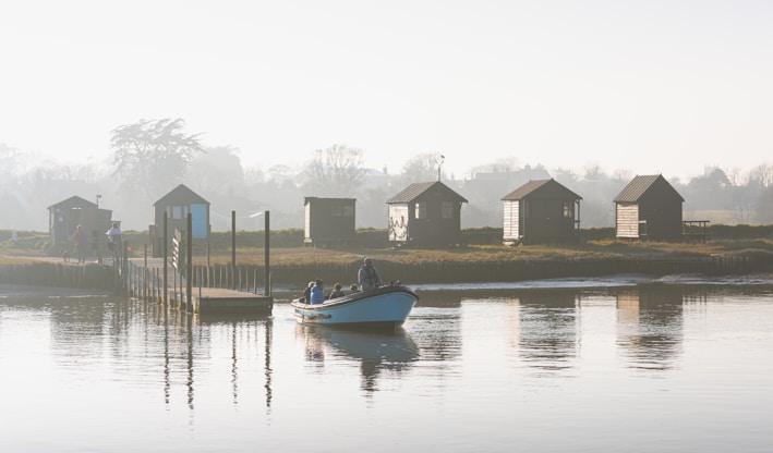 a small boat floating on top of a body of water