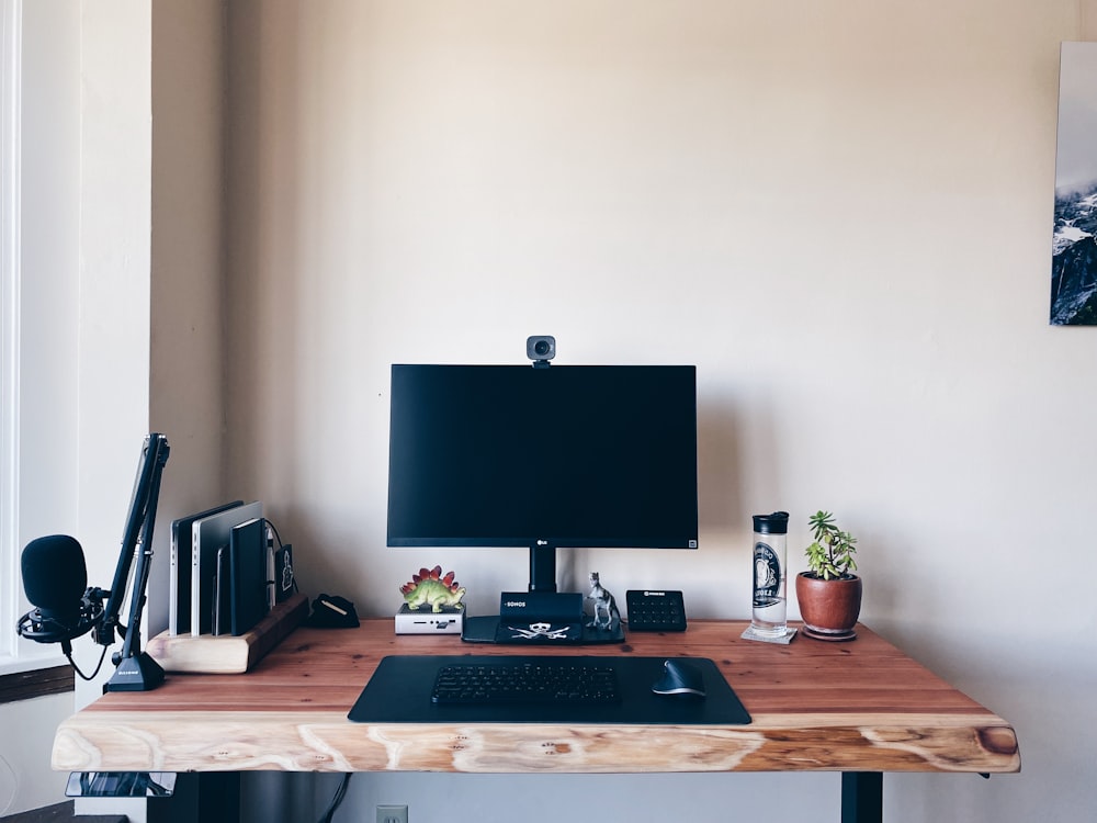 a wooden desk with a computer on top of it