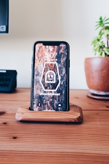 a cell phone sitting on top of a wooden table