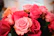 A close-up photo of a vibrant eternal rose bouquet with satin ribbons in soft pastel tones.