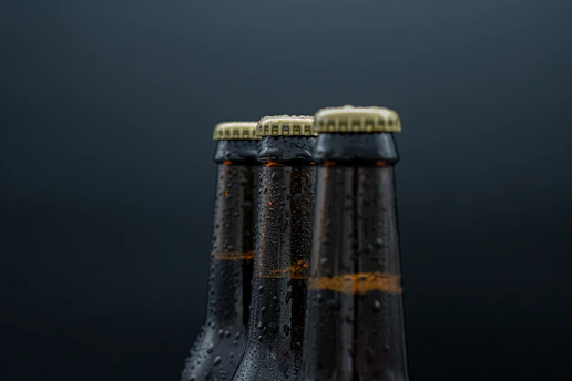 a close up of three bottles of beer