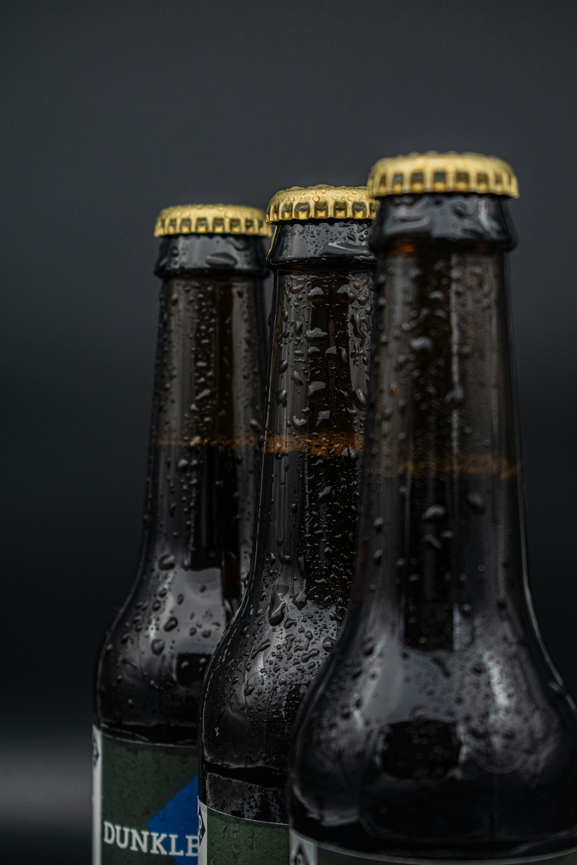 three bottles of dunkin'donuts beer sitting next to each other