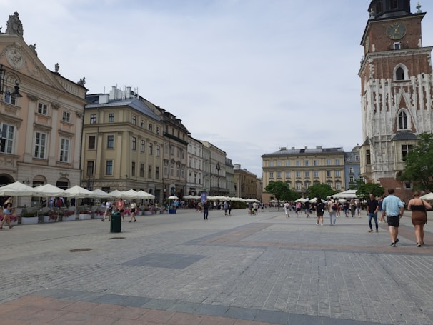 Historic city square with charming old buildings and people enjoying outdoor cafes.