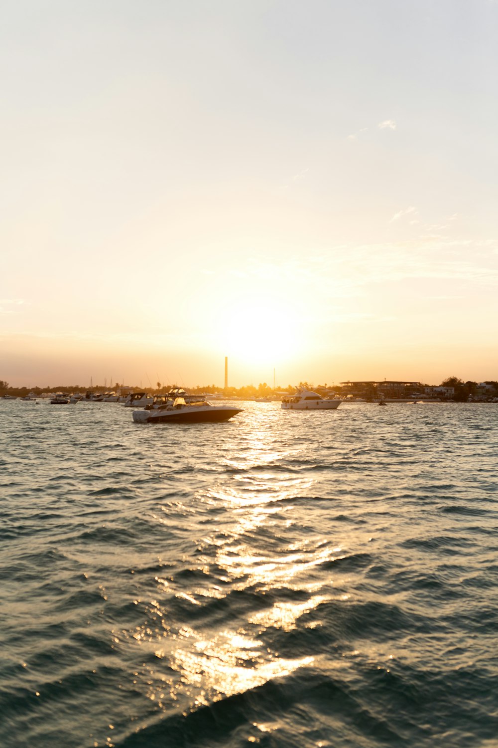 the sun is setting over a body of water