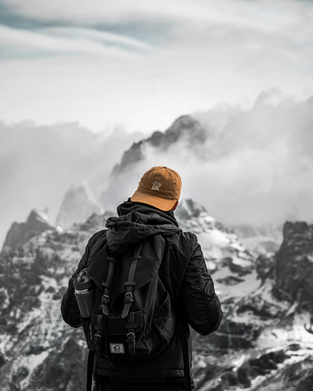 a man standing on top of a snow covered mountain