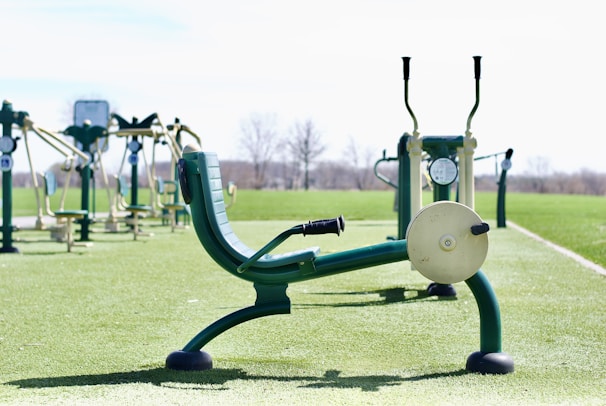 A lineup of the latest men's fitness gadgets with an outdoor gym setup.