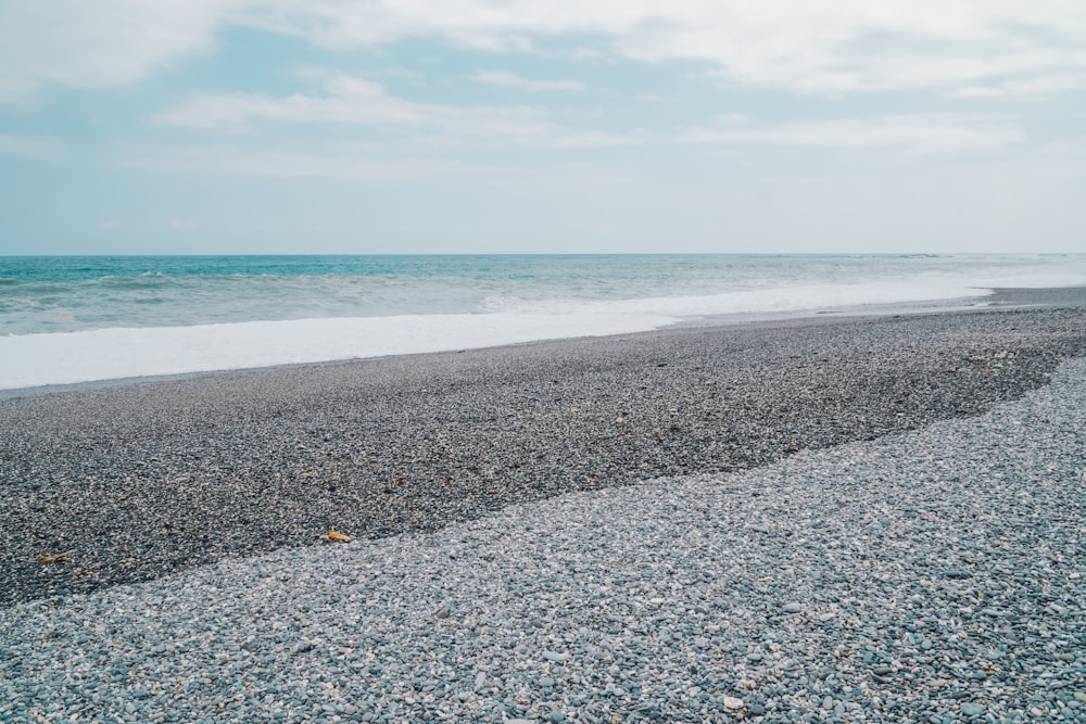 a beach that has a bunch of rocks on it