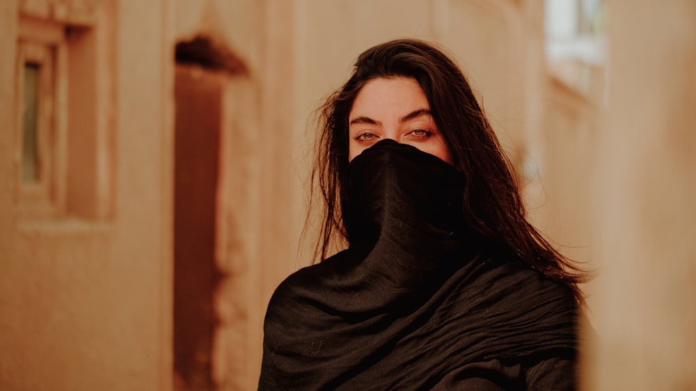 a woman with a black shawl covering her face