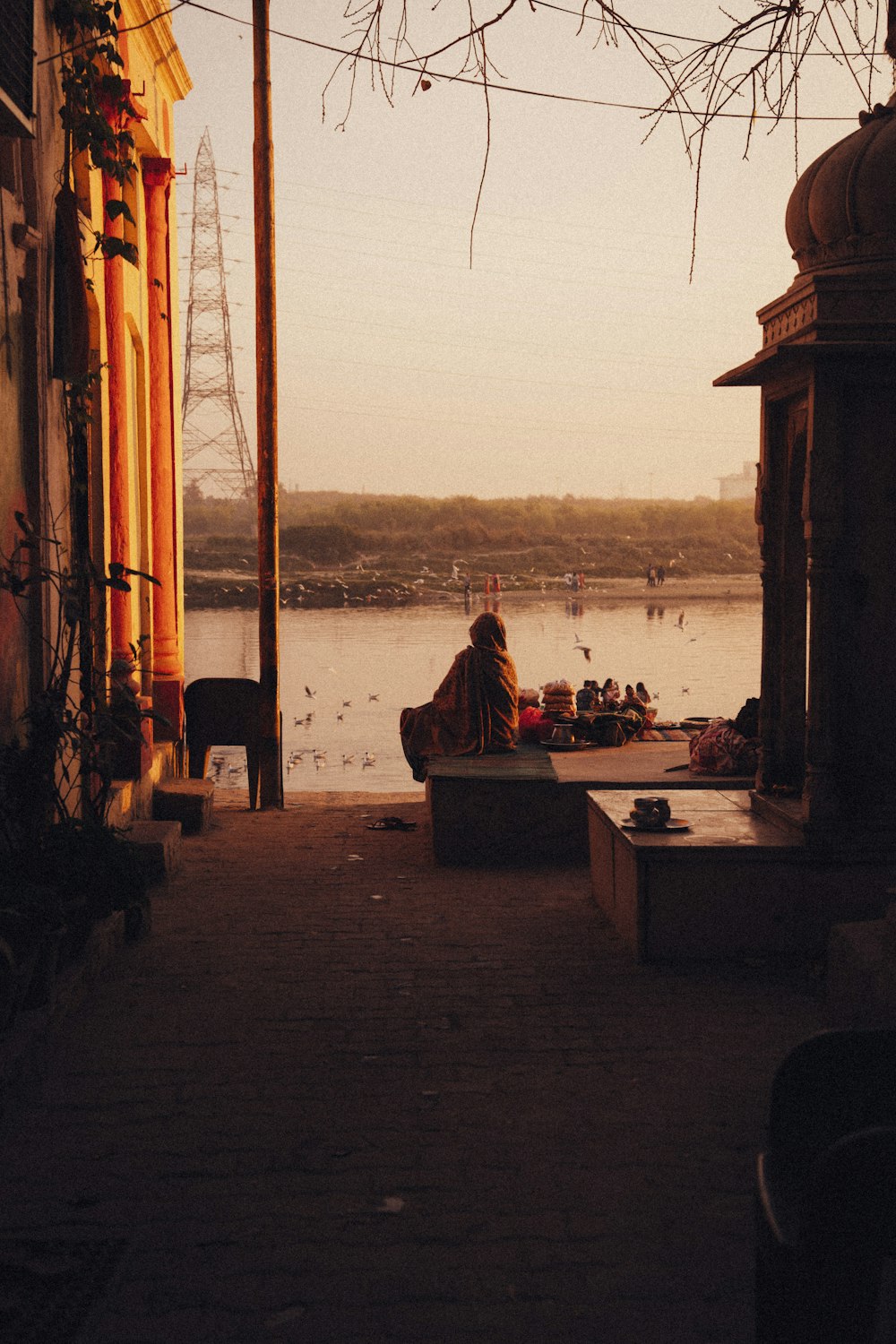 a person sitting on a bench near a body of water