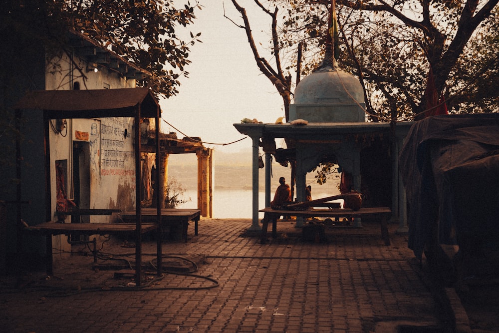 a person sitting on a bench near a body of water