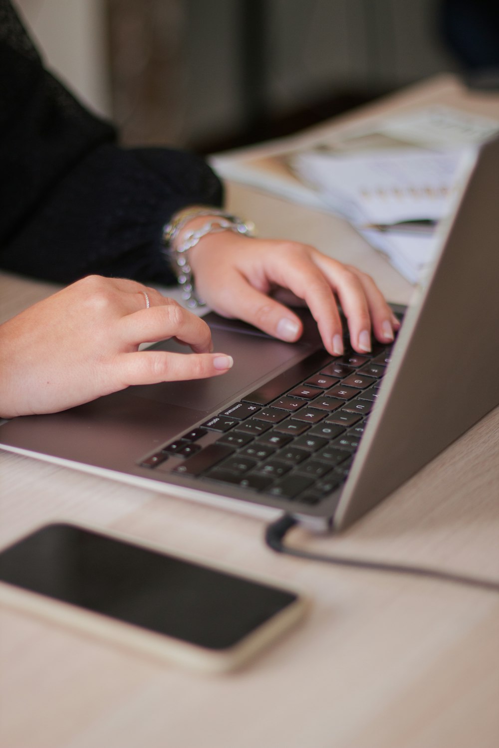 a person typing on a laptop on a table