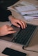 a person typing on a laptop on a desk
