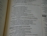 Close-up of an open book with artistic typography and bold illustrations from Novacula