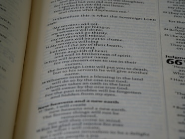 Close-up of an open book showing elegant serif typography on warm ivory pages.