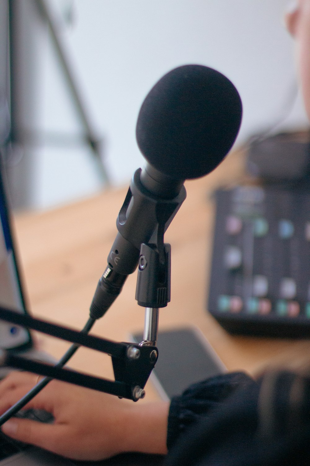 a person using a laptop and a microphone