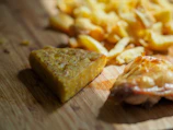 Close-up of a stack of golden plenty tortillas on a rustic wooden board.