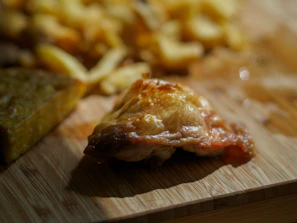 Warm-lit photo of a sizzling plate of jerk chicken with plantains and rice, steam rising.