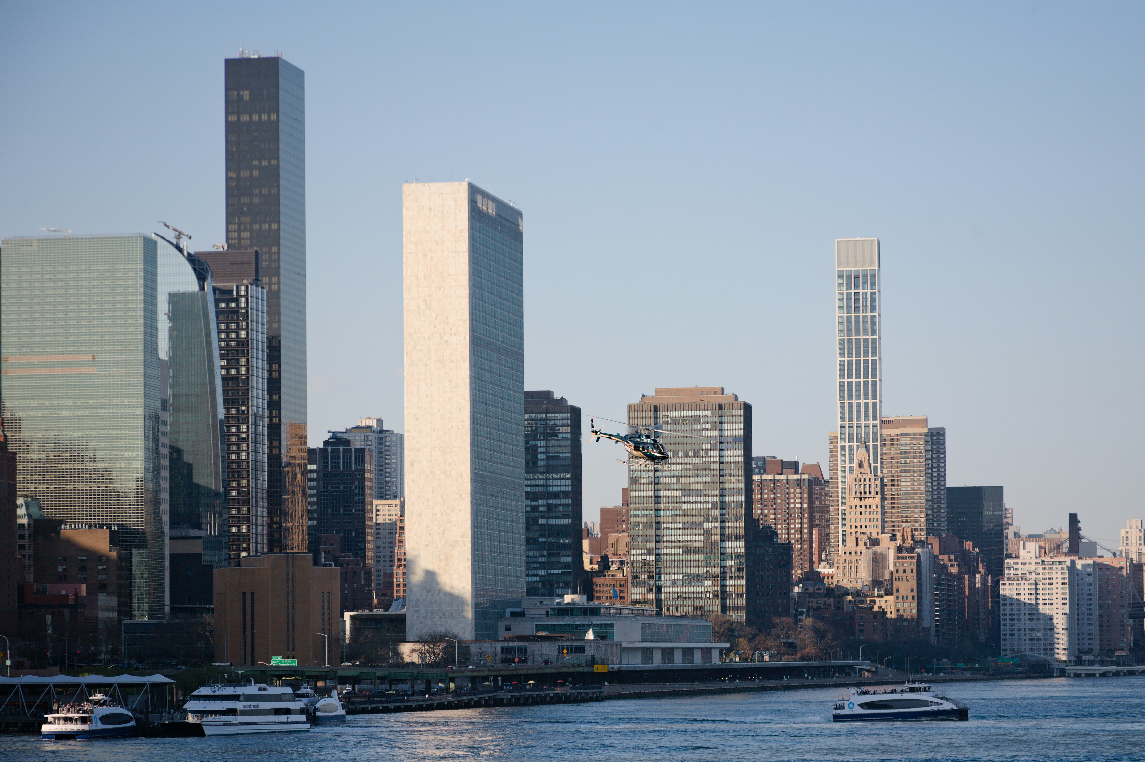 a large body of water with a city in the background, 