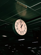 a large clock hanging from the ceiling of a building