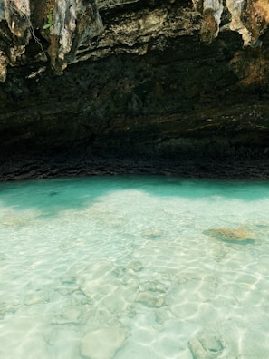 A crystal-clear lagoon perfect for snorkeling with vibrant coral reefs visible below.