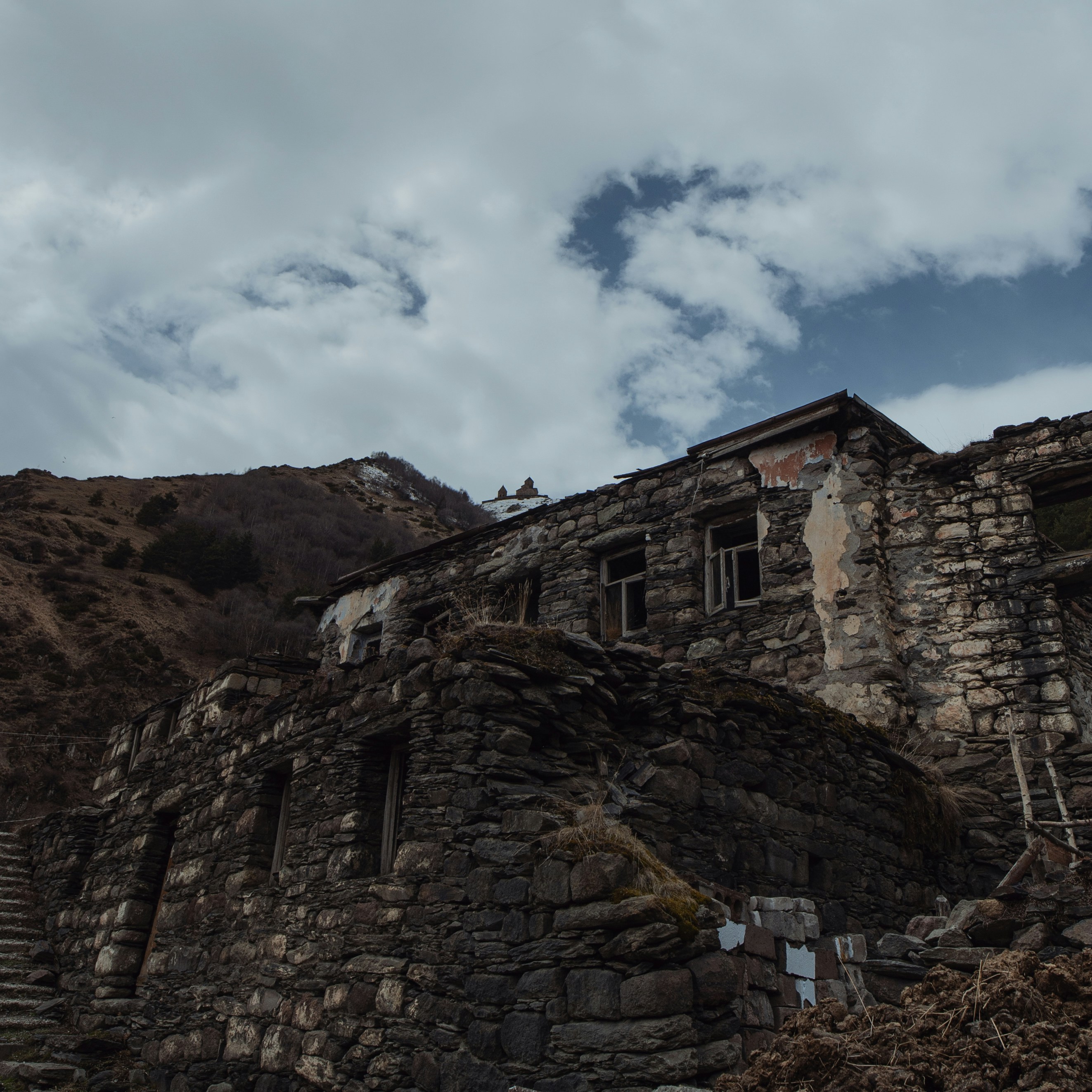 a stone building sitting on top of a mountain