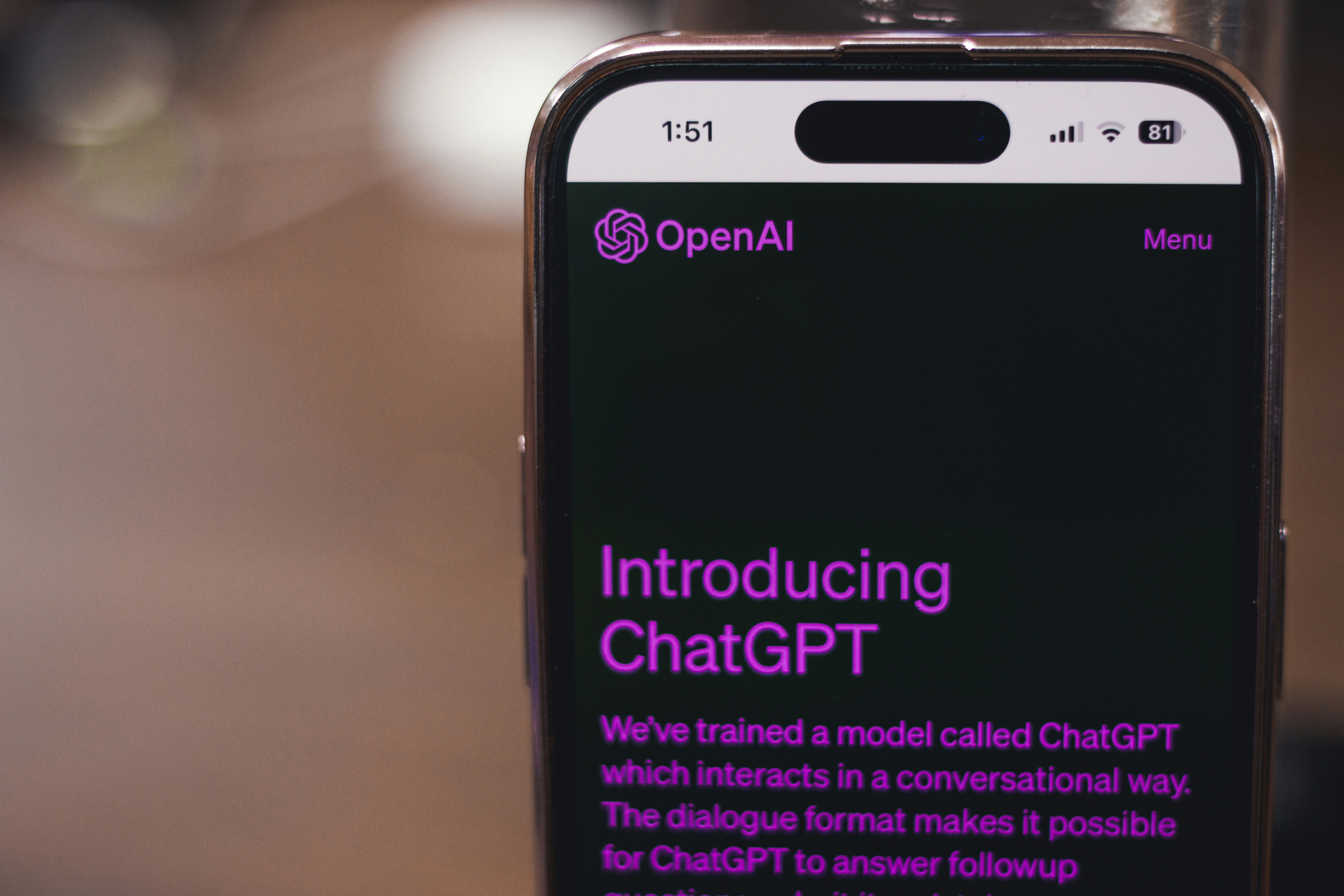 Webpage of ChatGPT, a prototype AI chatbot, is seen on the website of OpenAI, on a smartphone. Examples, capabilities, and limitations are shown.