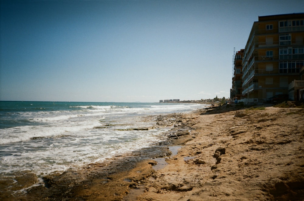 a view of a beach with a building in the background