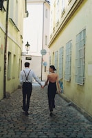 A couple taking a romantic stroll in a historic city.
