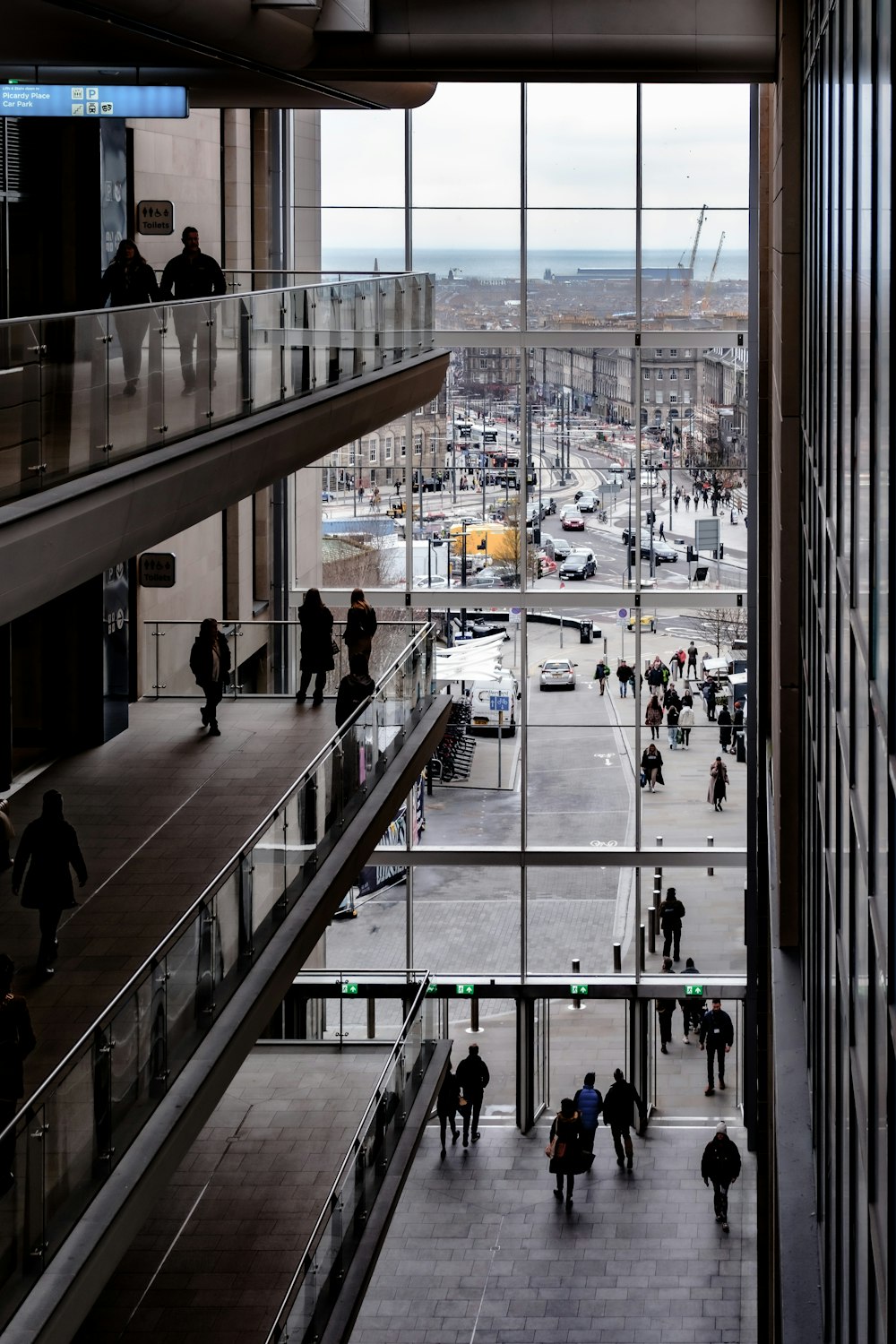 a group of people walking around a building