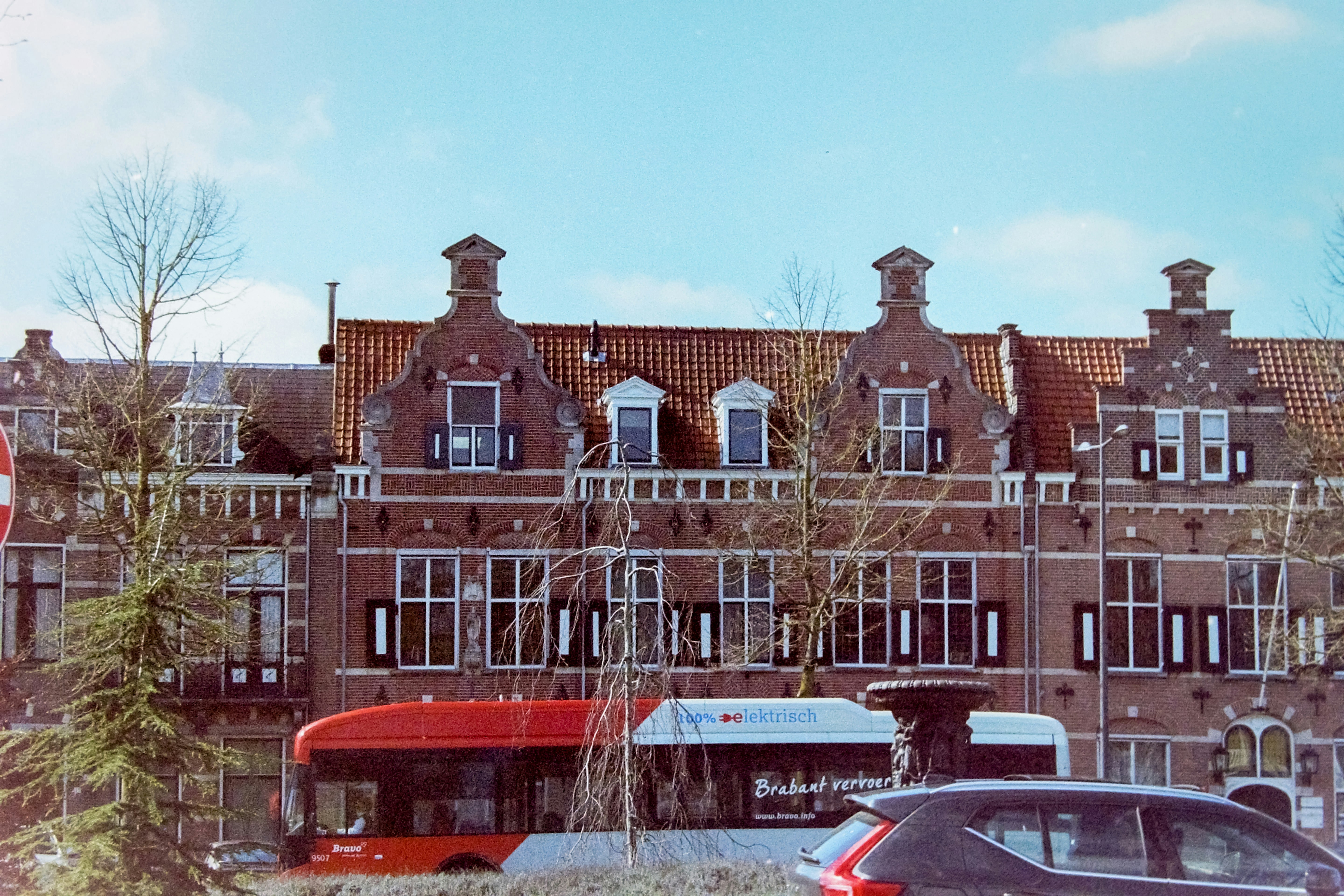 a red double decker bus parked in front of a building