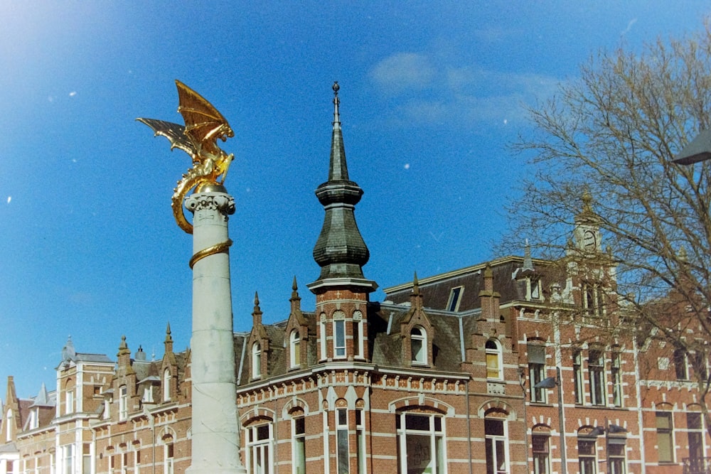 a large building with a golden dragon statue in front of it
