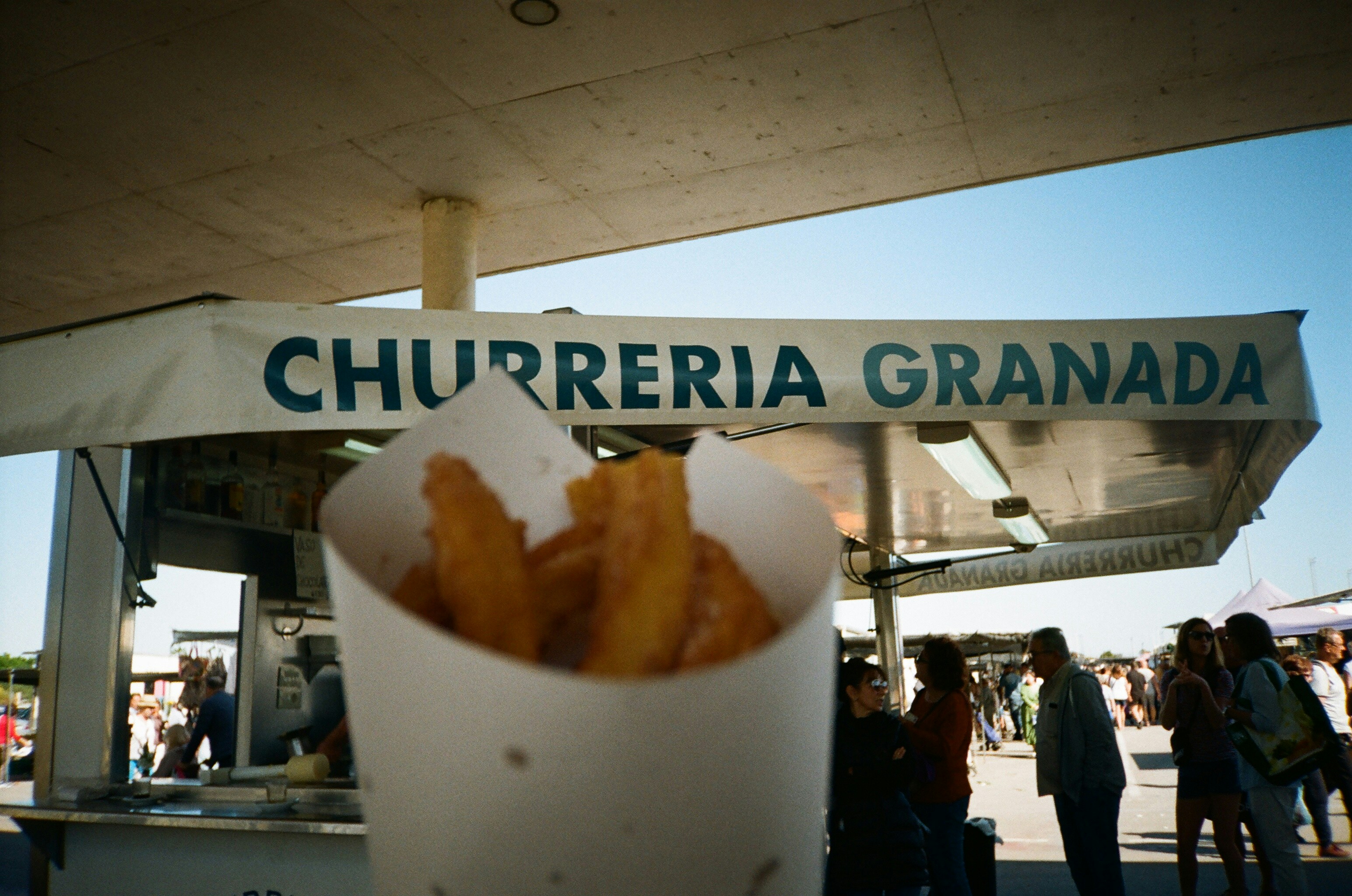 a close up of a cup of food with a sign in the background