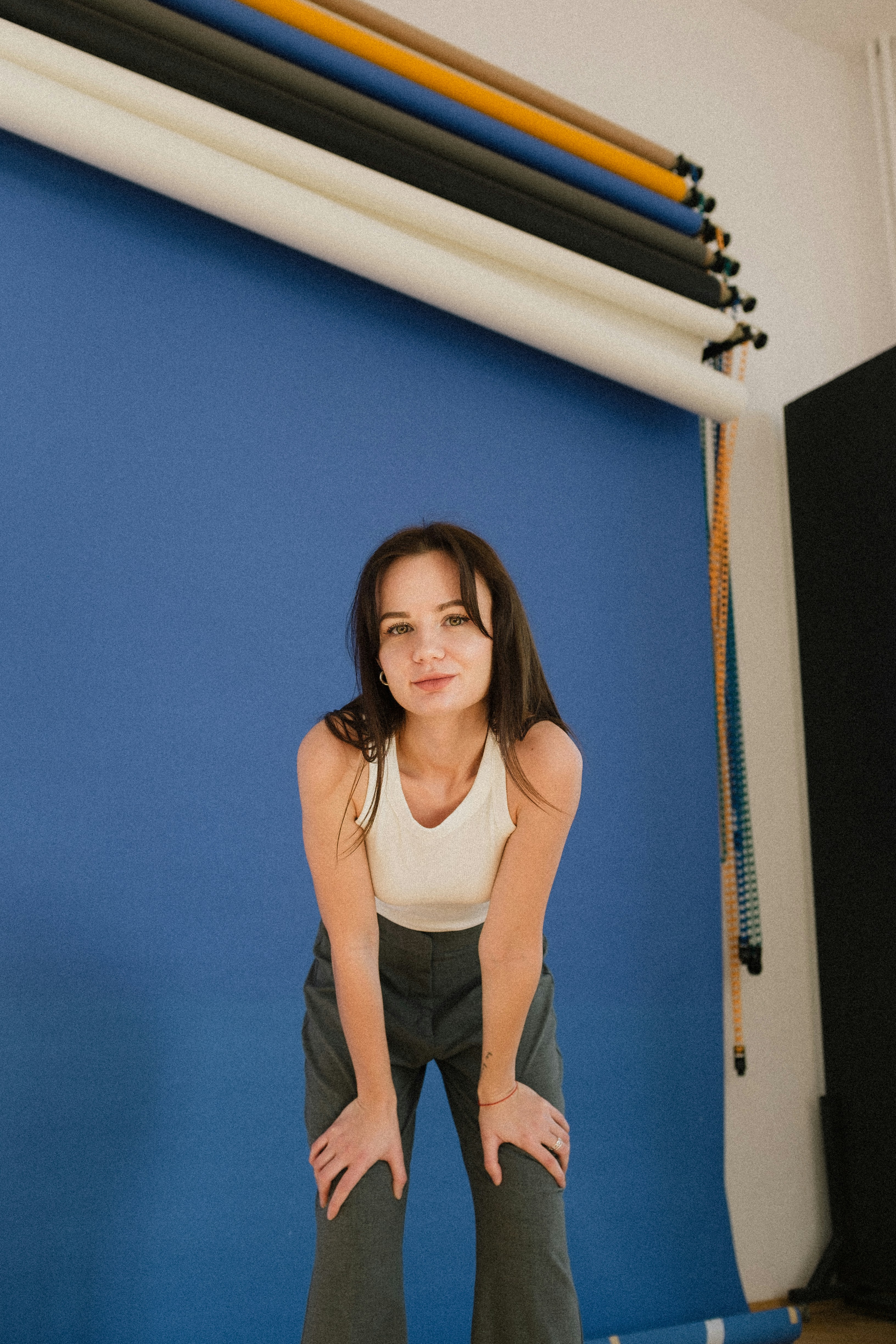 a woman standing in front of a blue wall