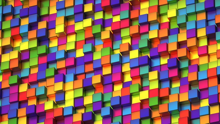A vibrant array of multicolored 3D cubes stacked closely together in a random pattern. The cubes display a range of bright colors, creating a dynamic and lively visual effect.